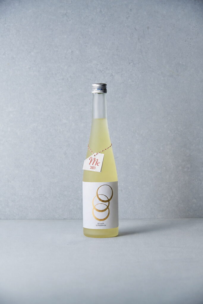 Bottle of "Me" unfiltered raw liqueur with a hanging tag